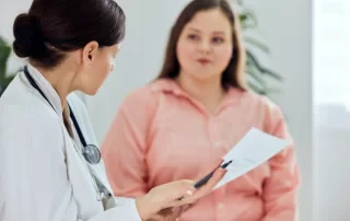 middle aged female patient talked with female doctor about treatment